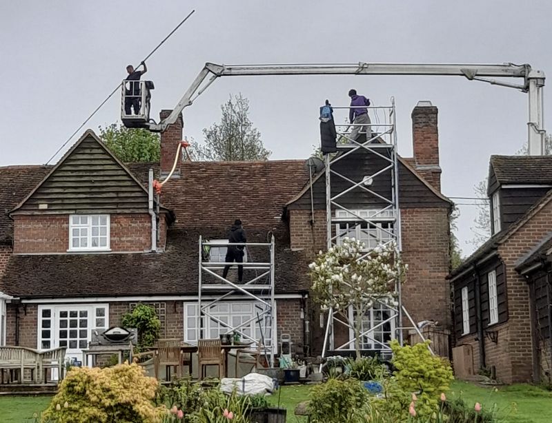 The Roof Moss Cleaners using cherry picker and scaffolding to clean roof safely and professionally in Tetbury, Gloucestershire
